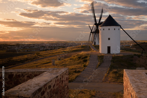 Exterior view of windmills on landscape in spring at sunset in Alcazar de San Juan, Ciudad Real, Spain