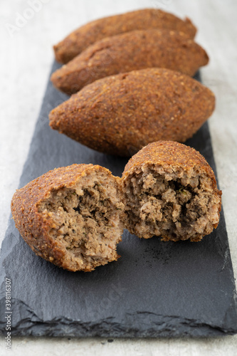 Traditional arabic fried kibbeh over stone board. Typical brazilian snack