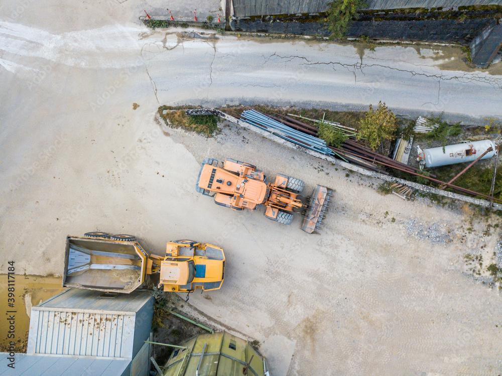 Aerial view of wheel loader in gravel pit for industrial mining. Aerial view of wheel loader in gravel pit for industrial mining.