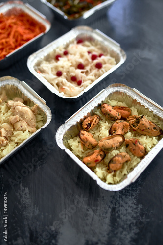 Different foil containers with delicious food.