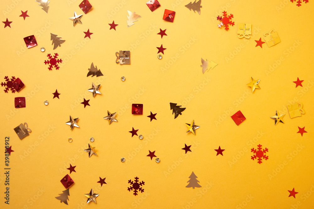 Christmas sparkles in the form of a Christmas tree, gifts, stars on a yellow background. High quality photo