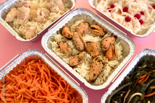 Different foil containers with delicious food.