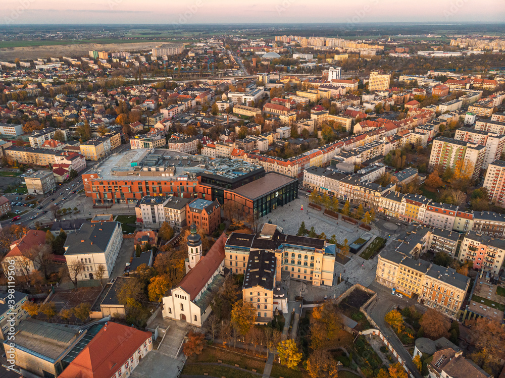 A drone view of the historic city with the market square, churches and the town hall in Opole during sunset. Autumn in Silesia - Poland.