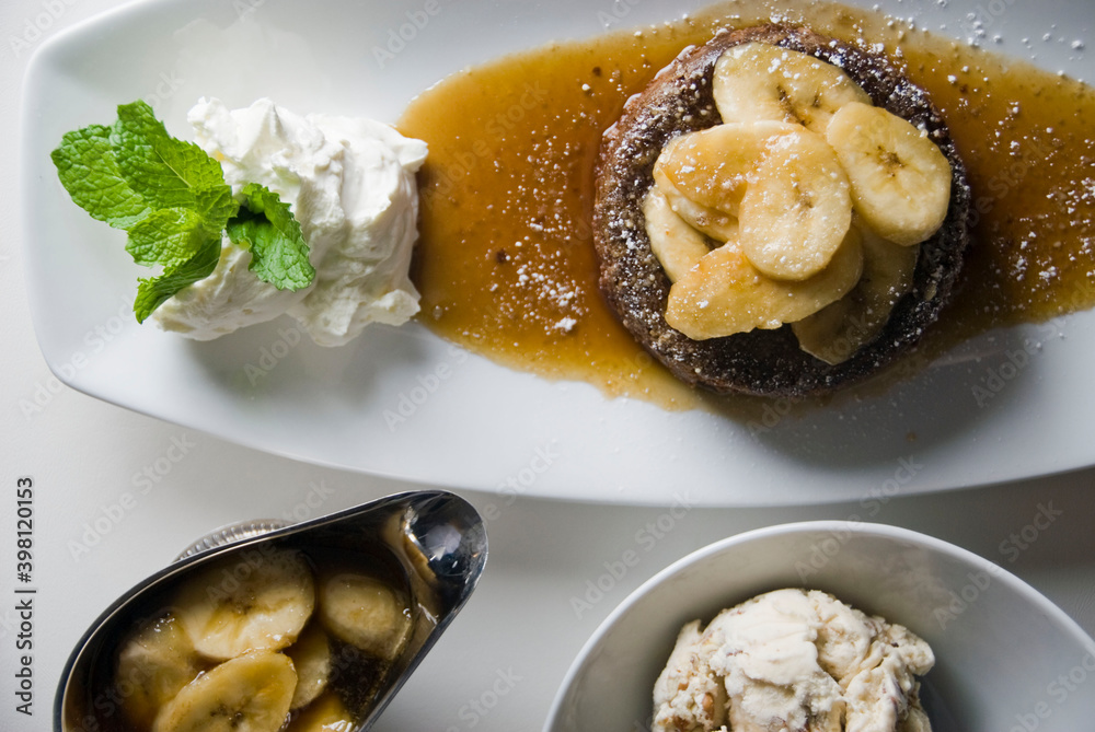 Bananas foster Dessert. Classic Creole or Cajun dessert favorite. Bananas sautéed in butter and caramelized sugar and served with cookies, whipped cream, cake, ice creams and chocolate syrup. Bananas foster Dessert. Classic Creole or Cajun dessert favorite. Bananas sautéed in butter and caramelized sugar and served with cookies, whipped cream, cake, ice creams and chocolate syrup.