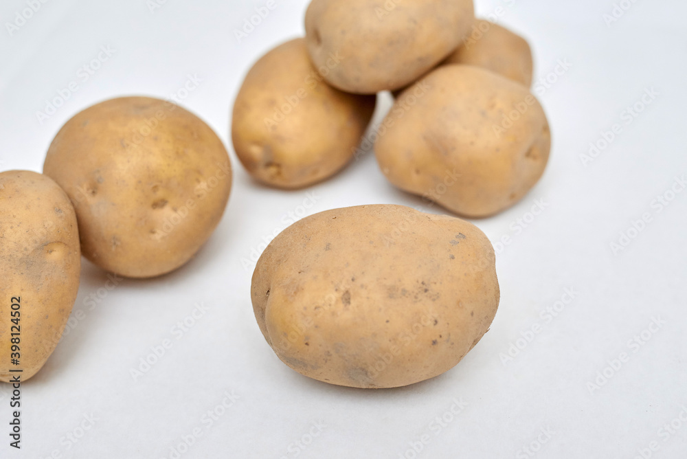 fresh unpeeled potatoes on a white background fresh unpeeled potatoes on a white background