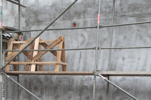 The appearance of a gray wall on a construction site with construction trestles