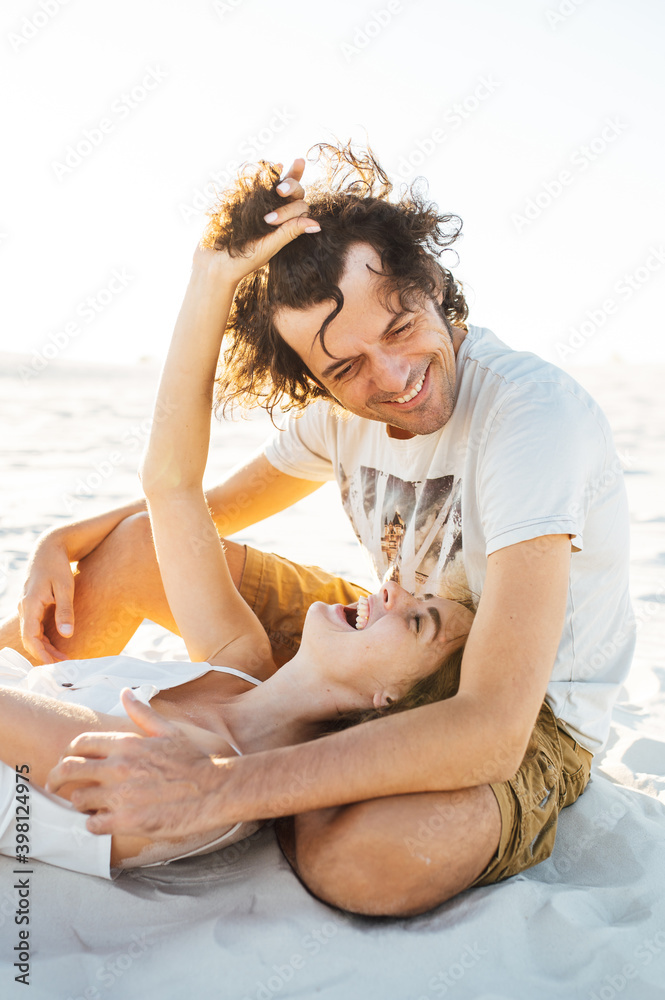 A mischievous girl lies on the lap of her beloved and holds him by the hair. A mischievous girl lies on the lap of her beloved and holds him by the hair.