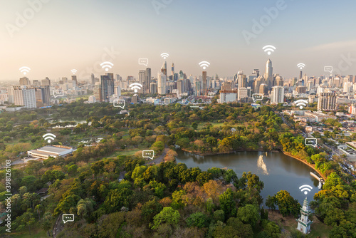 Lumpini (Lumphini) Park and Bangkok city in Thailand viewed from above. Wireless network connection, WiFi, smart city and online messaging concept.