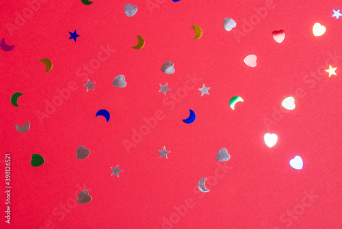 shiny confetti on matte red background