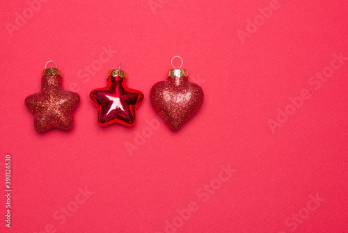 red Christmas tree toys lined up against a red background © Jeine