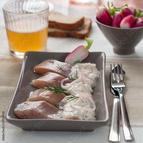 Pickled Herring with Sour Cream and Onion. Glass of Beer