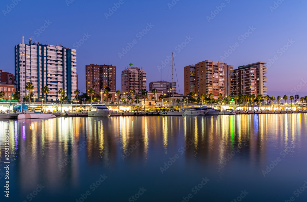 Overview of City and Reflection of Lights on Malaga Port Water
