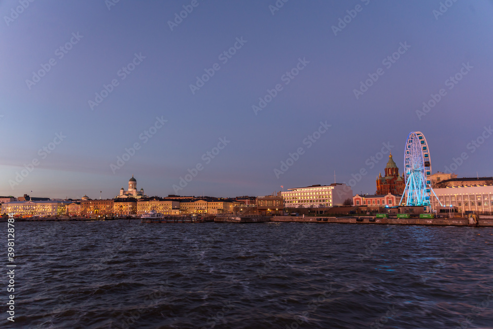 Naklejka premium Scenic night view of the Old Town architecture and pier and Lutheran Christian Cathedral Church at the Senate Square in Helsinki, Finland, panoramic Presidential house.View Of Evening City Uspenski.
