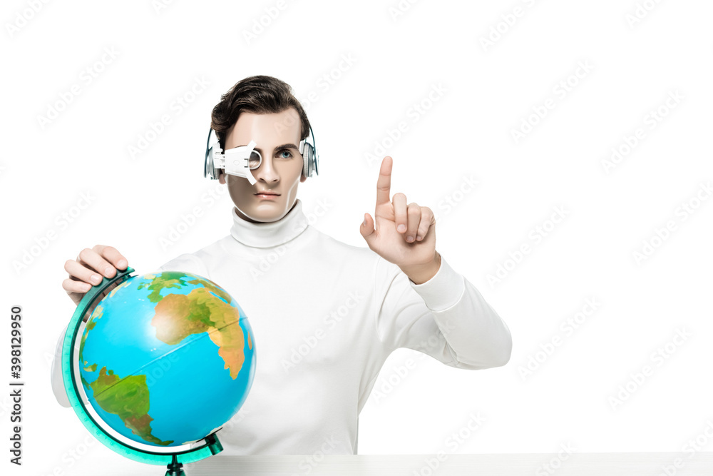 Cyborg in digital eye lens and headphones pointing with finger near globe isolated on white Cyborg in digital eye lens and headphones pointing with finger near globe isolated on white