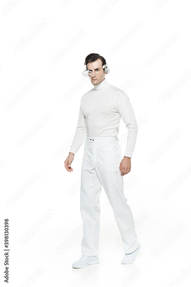 Cyborg in digital eye lens and headphones walking isolated on white Cyborg in digital eye lens and headphones walking isolated on white