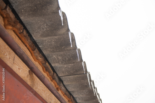 icicles hang from the edge of the roof