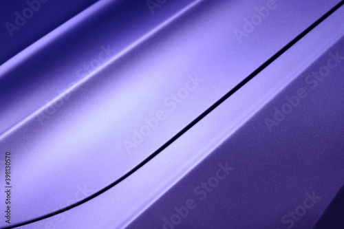 Violet car bodywork detail, part of hood and fender of sport sedan, steel gradient line pattern, automobile industry, horizontal selective focus 