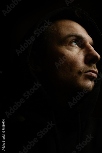 Man on a dark background with a neutral expression. Film grain and noise effect.