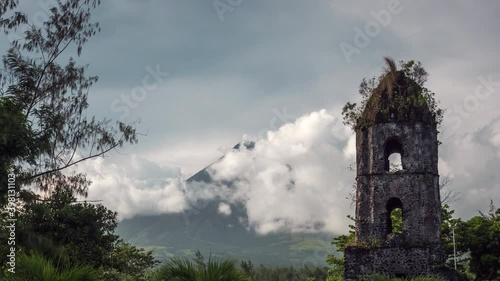 Timelapse view of historical landmark Cagsawa Ruins and Mount Mayon volcano near Legazpi City, Albay, Philippines.  photo