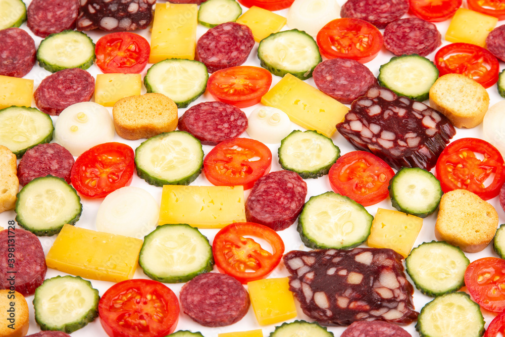 sliced pieces of sausage, salami, cheese, cucumber and tomato. fast food. ingredients for pizza. calories and diet sliced pieces of sausage, salami, cheese, cucumber and tomato. fast food. ingredients for pizza. calories and diet