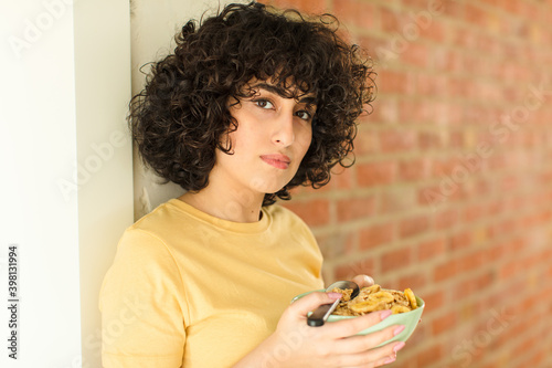 young pretty woman having breakfast at home photo