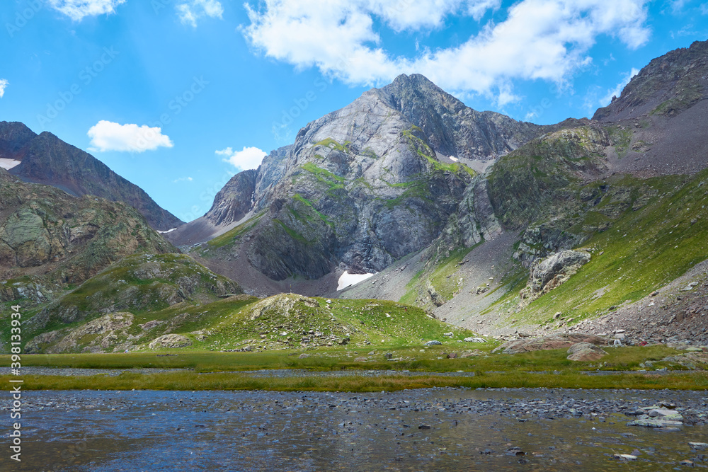 Sunny day of hiking on the snowy mountain in the blue lakes of Panticosa, Spain