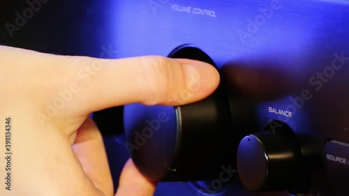 A woman's hand brings sound volume up and makes louder closeup