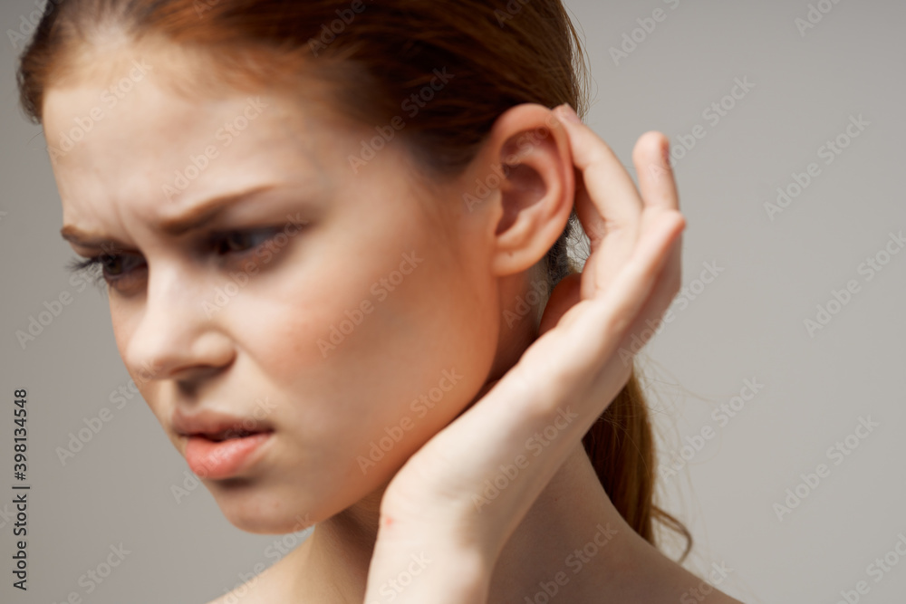 disgruntled woman holding her ear health problems close-up disgruntled woman holding her ear health problems close-up
