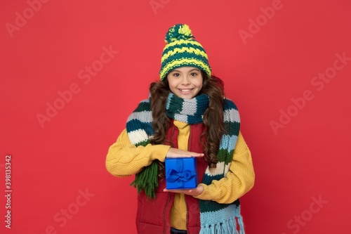 Nice purchase. buy presents and gifts for christmas. happy childhood. teen girl hold box. knitted clothing style. new year holiday. cheerful child wear warm winter clothes. seasonal shopping sales