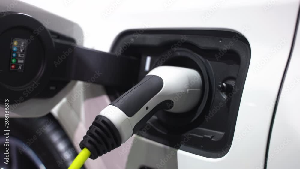 Electric vehicle charging port plugging in EV modern car. save ecology alternative energy sustainable of future Electric vehicle charging port plugging in EV modern car. save ecology alternative energy sustainable of future