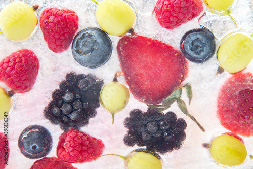 Fototapeta Naklejka Na Ścianę i Meble -  different juicy berries frozen in ice. useful vitamin healthy food