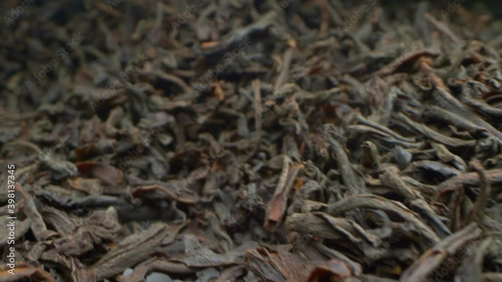 extremely close-up, detailed. background of scattered black leaf tea. extremely close-up, detailed. background of scattered black leaf tea.