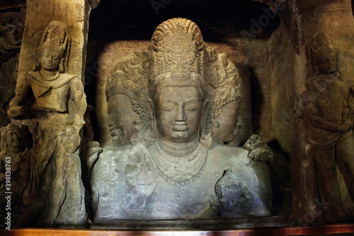 Mumbai, India - October 23, 2018: Interior of a Trimurti sculpture of Elephanta cave, late Gupta dating from between the 9th and 11th centuries, UNESCO World Heritage Site photo