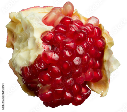 juicy piece of pomegranate with skin close up, isolated on white background photo