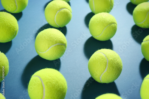 Tennis balls on blue background. Sports equipment © New Africa