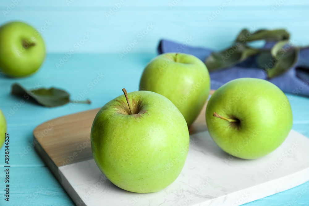 Ripe green apples on light blue wooden table Ripe green apples on light blue wooden table