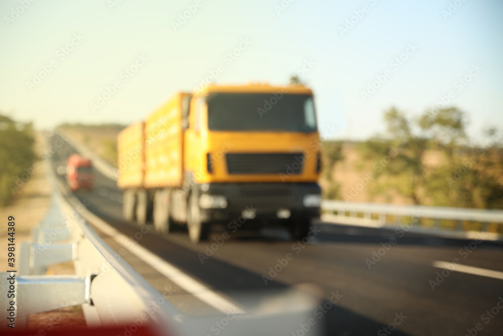 Blurred view of asphalt highway with truck. Road trip