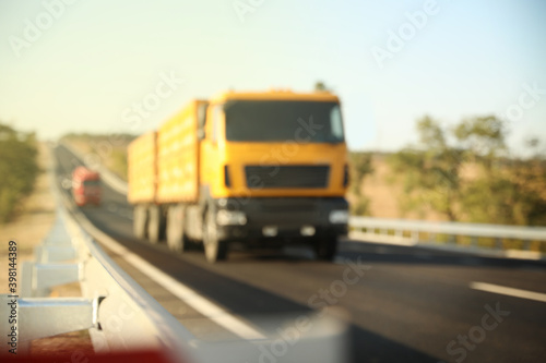 Blurred view of asphalt highway with truck. Road trip