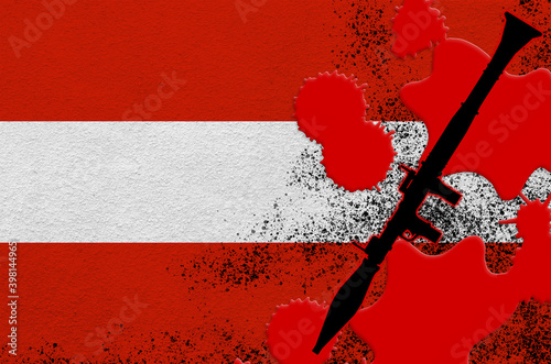 Austria flag and black RPG-7 rocket-propelled grenade launcher in red blood. Concept for terror attack or military operations with lethal outcome photo