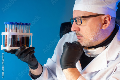 Virologist man examines tes...