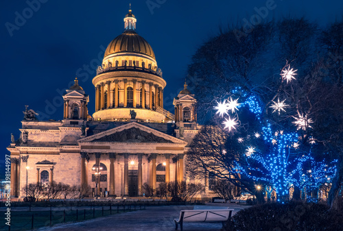 St. Isaac's Cathedral in Saint Petersburg. Christmas in Russia. Tree with Christmas garlands in front of St. Isaac's Cathedral. Saint Petersburg on New Year's evening. New Year's holidays in Russia
