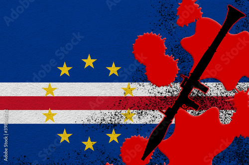 Cabo verde flag and black RPG-7 rocket-propelled grenade launcher in red blood. Concept for terror attack or military operations with lethal outcome photo