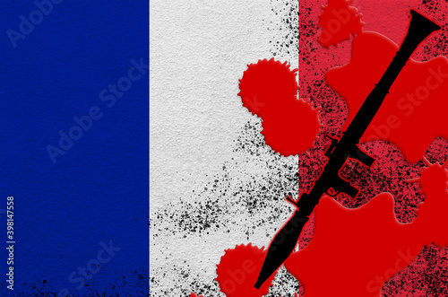 France flag and black RPG-7 rocket-propelled grenade launcher in red blood. Concept for terror attack or military operations with lethal outcome photo