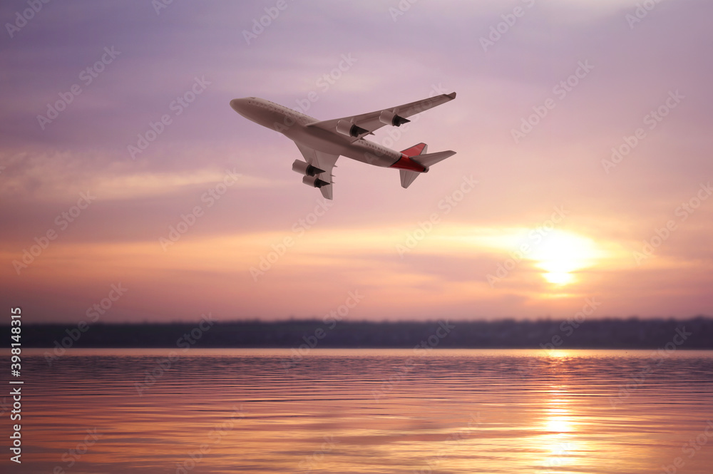 Modern airplane flying over river during sunset Modern airplane flying over river during sunset