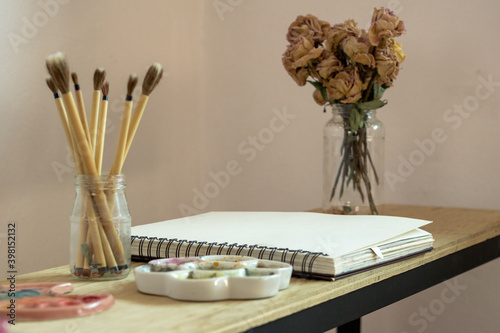 a brushes and notebook ready to paint with watercolor