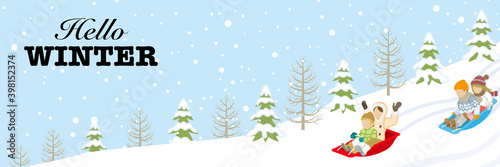 Children sledding in the winter snowcoverd slope - included greeting words "Hello WINTER"