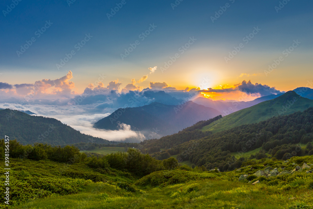 Beautiful mountain landscape at Caucasus mountains with clouds and blue sky