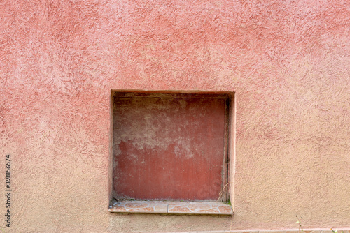 Pink wall gradient colored with a square cutout for dog pet window in Bulgaria, Eastern Europe