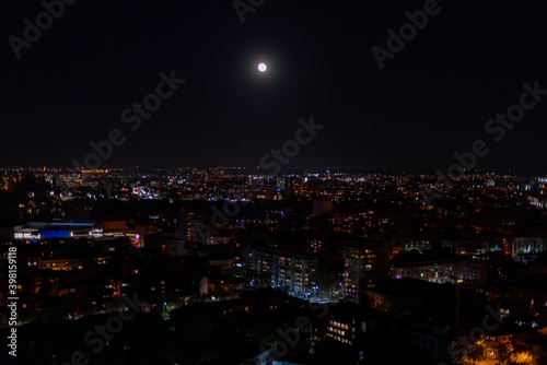 Big dark city lit up by moonlight and thousands of small lights high point view from hill peak of Plovdiv, Bulgaria