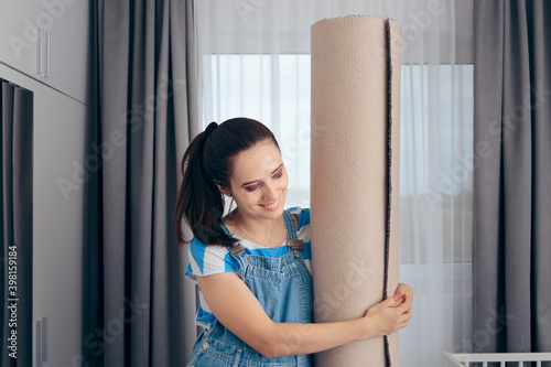 Free Download Cheerful Woman Holding New Carpet in Nursery Room - GFXLoad
